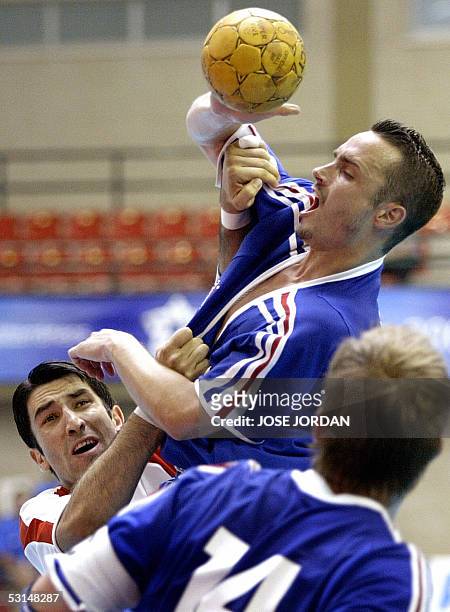 Spain: French Benoit Henry vies with Turkish Omer Savas during their handball match of the XV Mediterranean Games, 25 June 2005 in Roquetas de Mar,...
