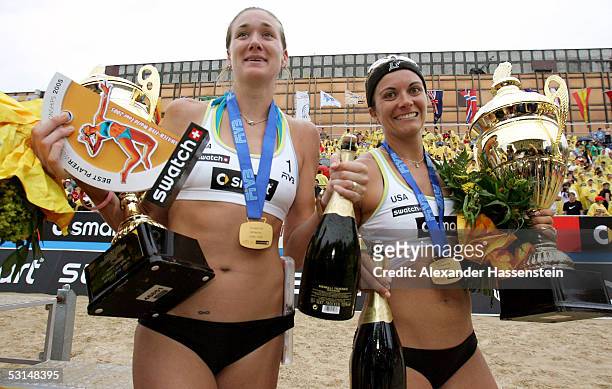 World champions Kerri Walsh and Misty May-Treanor of the United States of America pose with the World Champion trophy and their Gold Medals after...
