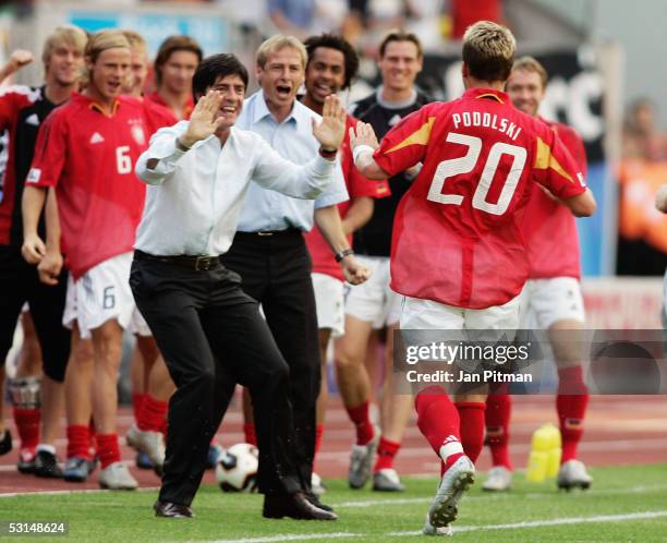 Juergen Klinsmann the German coach and his assistant Joachim Loew celebrate with goalscorer Lukas Podolski during the FIFA Confederations Cup 2005...