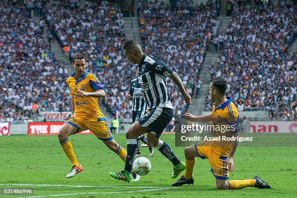 Edwin Cardona of Monterrey fights for the ball with Jesus Dueñas and Israel Jimenez of Tigres during the quarter finals second leg match between...