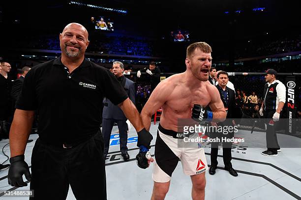 Stipe Miocic celebrates after defeating Fabricio Werdum of Brazil by KO in their UFC heavyweight championship bout during the UFC 198 event at Arena...