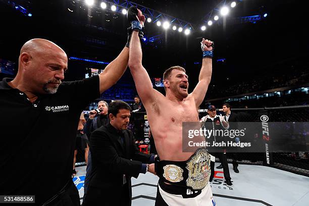 Stipe Miocic celebrates after defeating Fabricio Werdum of Brazil by KO in their UFC heavyweight championship bout during the UFC 198 event at Arena...