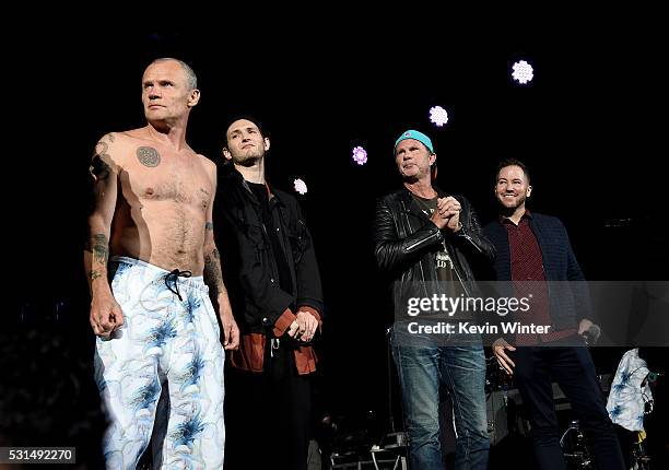 Recording artists Flea, Josh Klinghoffer, and Chad Smith of music group Red Hot Chili Peppers, and radio personality Ted Stryker stand onstage at...