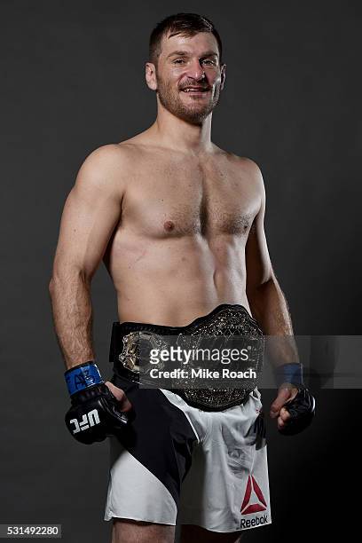 Stipe Miocic poses with his new UFC heavyweight championship belt backstage during the UFC 198 event at Arena da Baixada stadium on May 14, 2016 in...