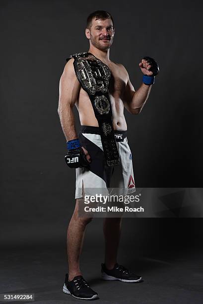 Stipe Miocic poses with his new UFC heavyweight championship belt backstage during the UFC 198 event at Arena da Baixada stadium on May 14, 2016 in...