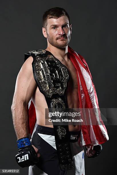 Stipe Miocic poses with his new UFC heavyweight championship belt backstage during the UFC 198 event at Arena da Baixada stadium on May 14, 2016 in...