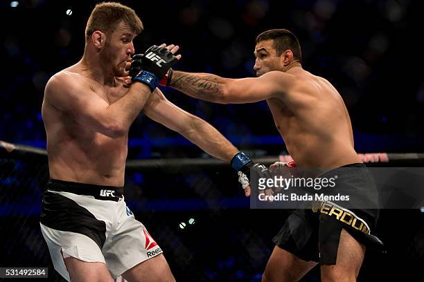 Fabricio Werdum of Brazil competes Stipe Miocic of the United States in their heavyweight bout during the UFC 198 at Arena da Baixada stadium on May...