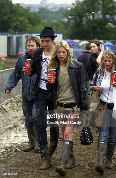 Kate Moss and Pete Doherty walk backstage on the second day of the Glastonbury Music Festival 2005 at Worthy Farm, Pilton on June 25, 2005 in...