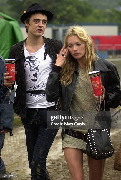 Kate Moss and Pete Doherty walk backstage on the second day of the Glastonbury Music Festival 2005 at Worthy Farm, Pilton on June 25, 2005 in...