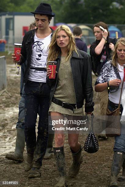 Kate Moss and Pete Doherty walk backstage on the second day of the Glastonbury Music Festival 2005 at Worthy Farm, Pilton on June 25, 2005 in...