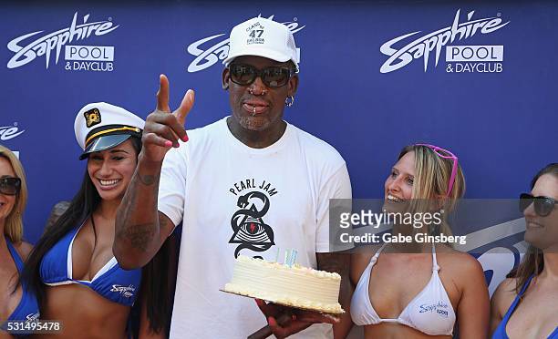 Former NBA player Dennis Rodman poses with models and a birthday cake at Sapphire Pool & Day Club to celebrate his birthday on May 14, 2016 in Las...