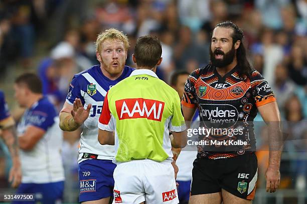 James Graham of the Bulldogs makes his point to the referee as Aaron Woods of the Tigers watches on during the round 10 NRL match between the Wests...