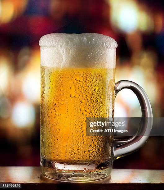 beer mug on bar with lights - beer glass fotografías e imágenes de stock