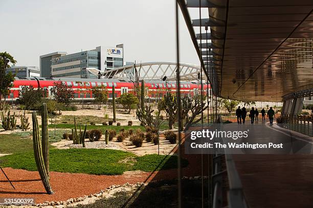 March 9: People are silhouetted as they walk along a shaded walkway connecting the Ben-Gurion University of the Negev to Gav-Yam Negev Advanced...