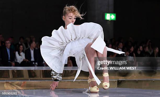 Model slips on the runway while parading an outfit by Australian designer Toni Maticevski at Fashion Week Australia in Sydney on May 15, 2016. / AFP...