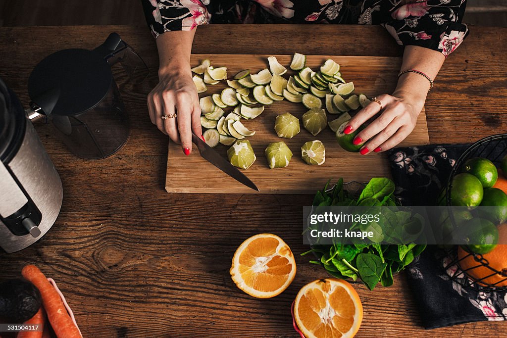 Woman juicing with fresh fruit