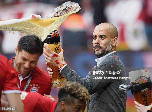 Josep Guardiola, coach of Bayern Muenchen throws his beer after winning the Bundesliga match between FC Bayern Muenchen and Hannover 96 at Allianz...