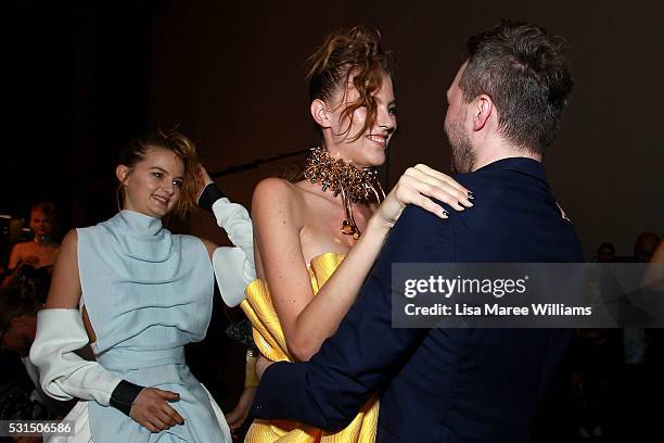 Designer Toni Maticevski celebrates with models backstage following the Mercedes-Benz Presents Maticevski show at Mercedes-Benz Fashion Week Resort...