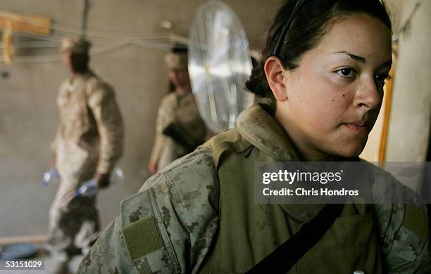 Marine Lance Cpl. Jillian Masmela of Boston, Massachusetts stands inside just before her shift as a female searcher at Entry Control Point 1, a...