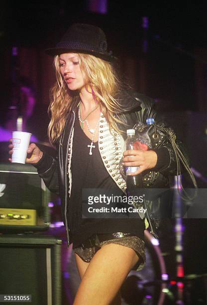 Kate Moss walks across the Leftfield Stage on her way to watch her boyfriend Pete Doherty and his band Babyshambles perform, on the second day of the...