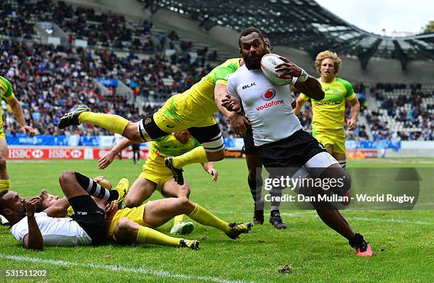 Osea Kolinisau of Fiji scores a try past Patrick McCutcheon of Australia during the Cup Quarter Final match between Fiji and Australia on day three...