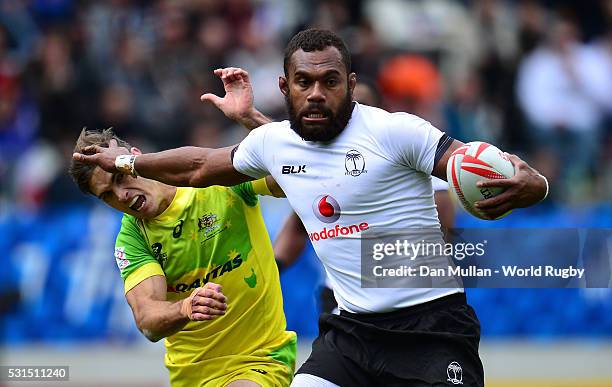 Osea Kolinisau of Fiji hands off Edward Jenkins of Australia during the Cup Quarter Final match between Fiji and Australia on day three of the HSBC...