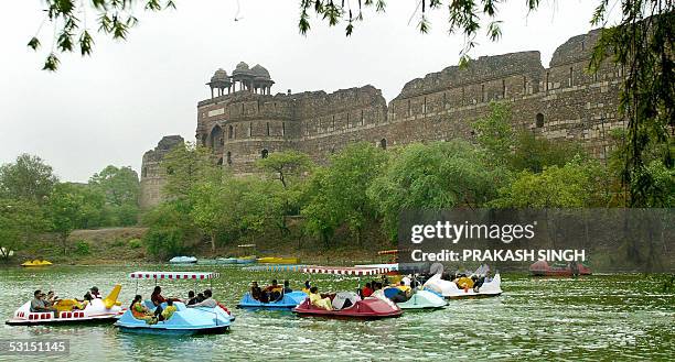 Indian families enjoy boating at Purana Quila during a downpour in New Delhi, 26 June 2005. Pre-monsoon rains in the capital have resulted in...