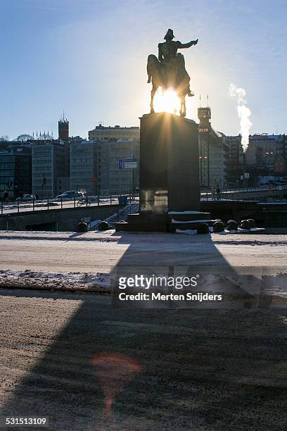stockholm winter sun through statue - charles xiv john of sweden stock pictures, royalty-free photos & images