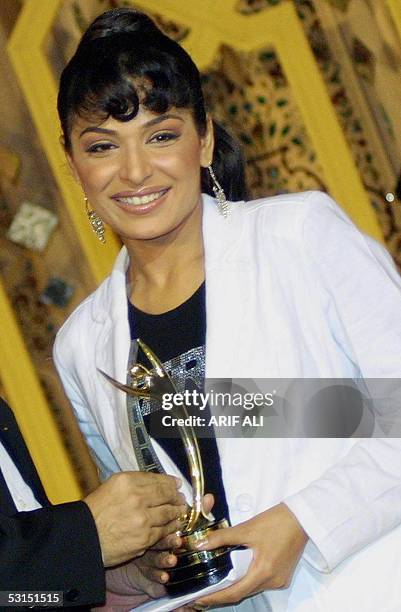 Popular Pakistani film actress Meera holds her award during the first Pakistan National Film Awards ceremony in Lahore, late 25 June 2005. The awards...