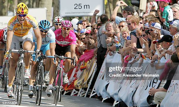 Gerald Ciolek of team Akud Arnold celebrates victory over second-place Robert Foerster of team Gerolsteiner and third-place Erik Zabel of team...