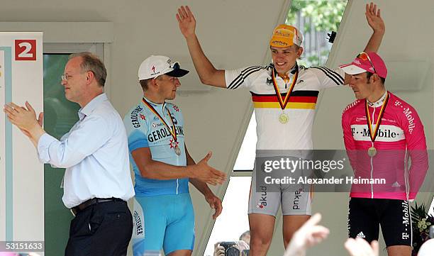 Gerald Ciolek of team Akud Arnold celebrates victory with second-place Robert Foerster of team Gerolsteiner and third-place Erik Zabel of team...