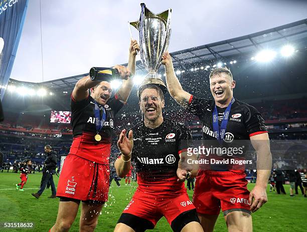 Alex Goode, Chris Wyles and Chris Ashton of Saracens celebrate after their vicotry during the European Rugby Champions Cup Final match between Racing...