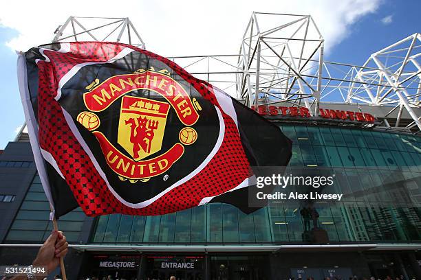 Supporter waves the flag prior to the Barclays Premier League match between Manchester United and AFC Bournemouth at Old Trafford on May 15, 2016 in...