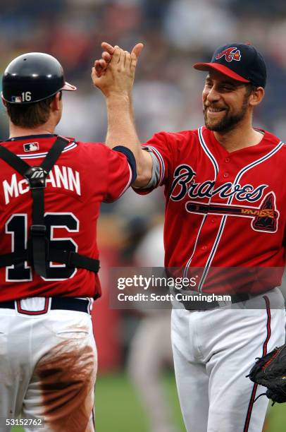 John Smoltz of the Atlanta Braves is congratulated by Brian McCann after a complete game win against the Baltimore Orioles on June 26, 2005 at Turner...