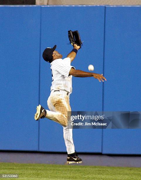 Tony Womack of the New York Yankees misses a play on a double hit by Chris Woodward of the New York Mets on June 26, 2005 at Yankee Stadium in the...