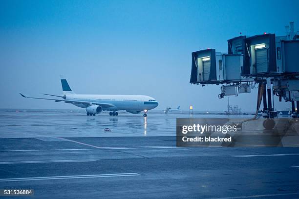 airplane landed and moving on the airport runway - airport cargo stock pictures, royalty-free photos & images