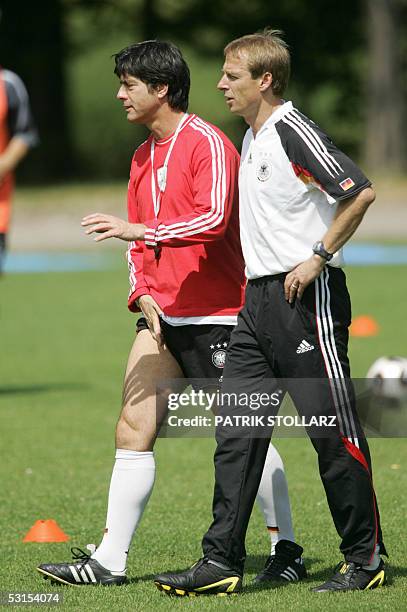 German deputy coach Joachim Loew and national team coach Jurgen Klinsmann practice with their players, during atraining session, 27 June 2005 at the...