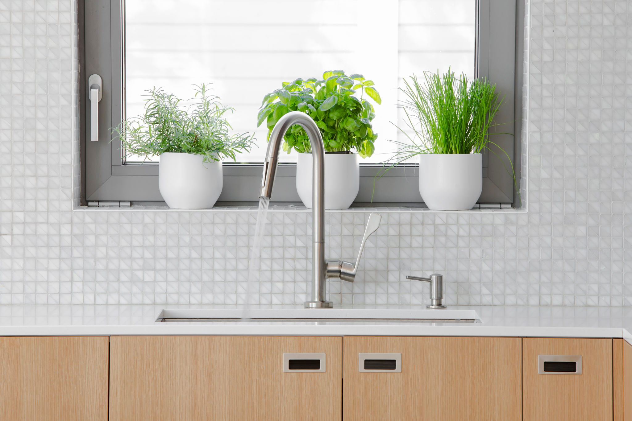 Modern kitchen Stainless steal faucet with water running into sink. Modern kitchen Stainless steal faucet with water running into sink.