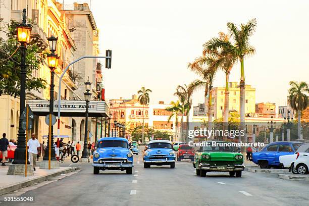 old cars in havana street - cuba culture stock pictures, royalty-free photos & images