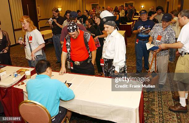George Takei signs autographs for fans.
