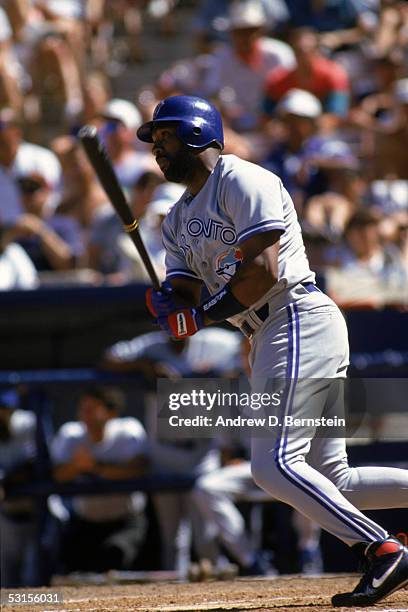 Joe Carter of the Toronto Blue Jays swings at the pitch during a game against the California Angels on September 5,1993 at Anaheim Stadium in...