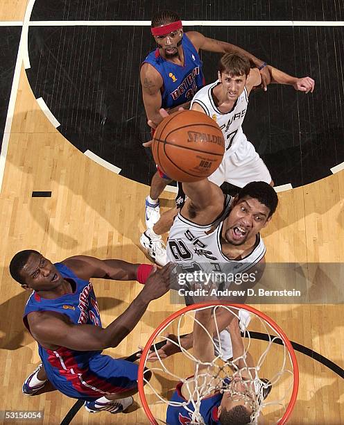 Tim Duncan of the San Antonio Spurs attempts a shot over Antonio McDyess and Tayshaun Prince of the Detroit Pistons in Game Seven of the 2005 NBA...