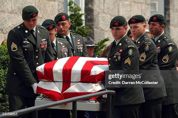 Army Special Forces soldiers carry the casket of their fallen comrade, Army Staff Sgt. Christopher Piper June 27, 2005 during his funeral procession...