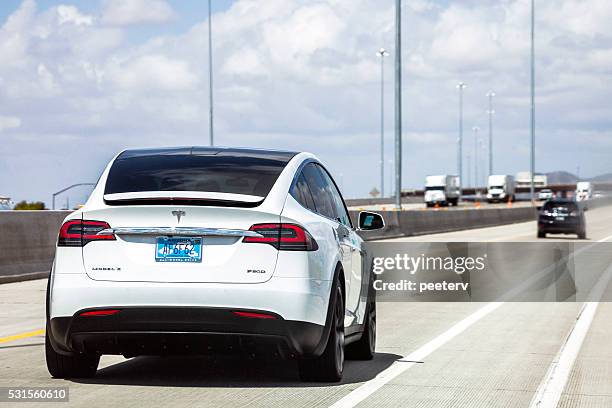 tesla model x on the road in arizona. - tesla model s stock pictures, royalty-free photos & images