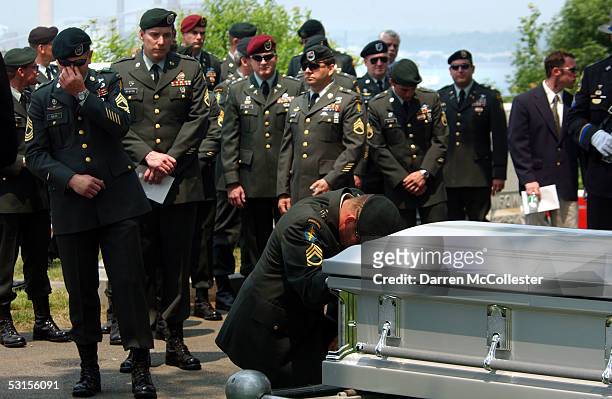 Special Forces soldiers grieve over the casket of their fallen comrade, Army Staff Sgt. Christopher Piper June 27, 2005 during his funeral in...