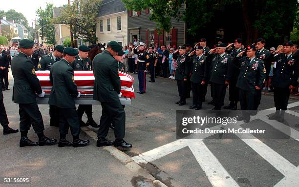 Special Forces soldiers carry the casket of their fallen comrade, Army Staff Sgt. Christopher Piper June 27, 2005 during his funeral procession in...