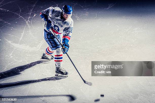 ice hockey player on the ice - ice hockey stock pictures, royalty-free photos & images