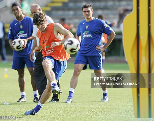 Germany: Brazil's midfielder Juninho kicks a ball under the eyes of Ronaldinho and defender Lucio during a training session of the Brazilian national...