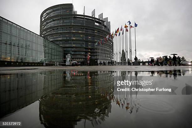 People make their way into the European Parliament during a rain storm on May 12, 2016 in Strasbourg, France. The United Kingdom will hold a...