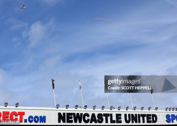 Aeroplane towing the message "Auf Wiedersehen prem tyne to go" is seen in the sky above the English Premier League football match between Newcastle...